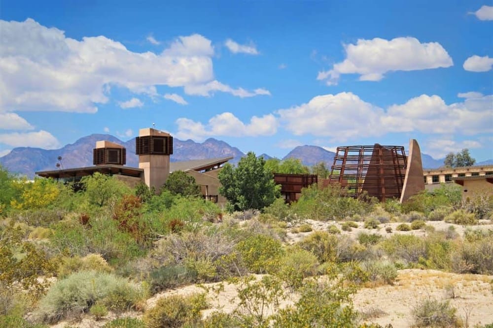 Modern desert architecture with mountains in the background at QuestForDirections.