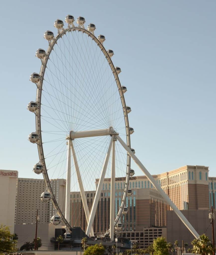 A giant Ferris wheel at The Venetian hotel in Las Vegas under clear blue sky.