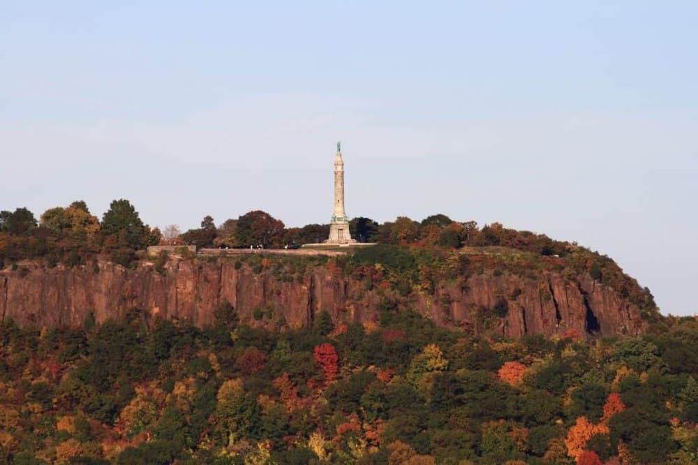 Stone Mountain monument in Georgia with fall foliage surrounding it, ideal for sightseeing and outdoor adventures.