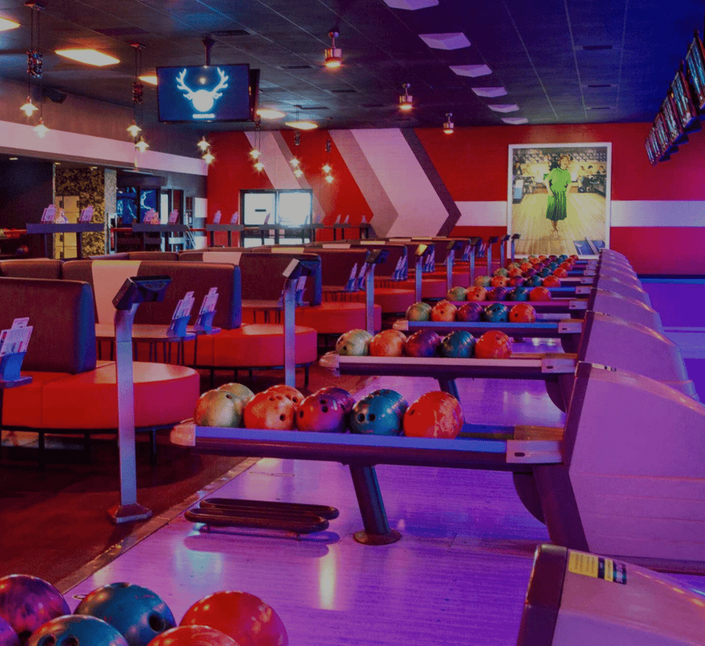 Colorful bowling alley with lanes, balls, and vibrant lighting for entertainment and fun.
