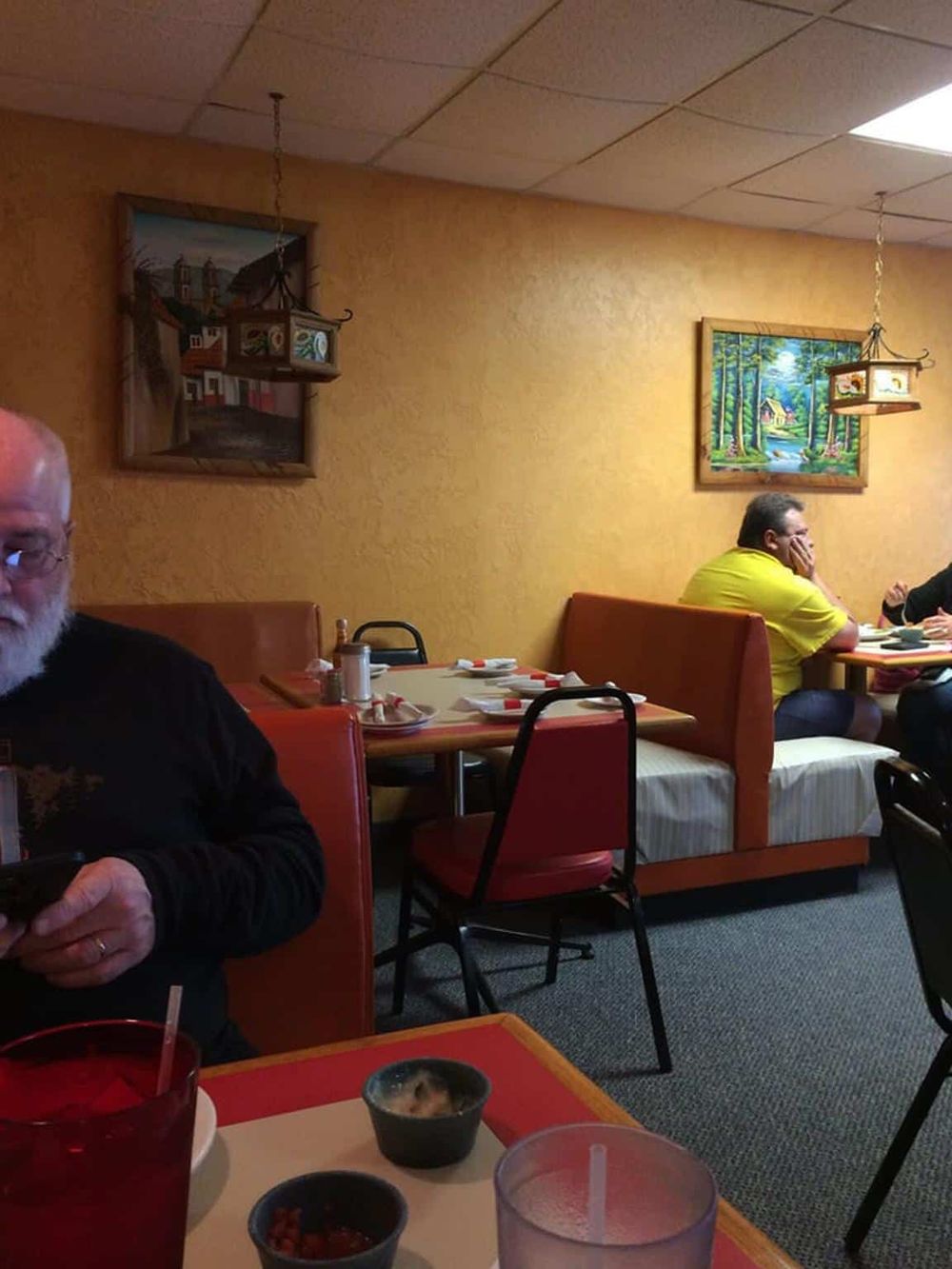 Cozy restaurant interior with themed wall art and vibrant decor, ideal for diners seeking a welcoming dining experience.