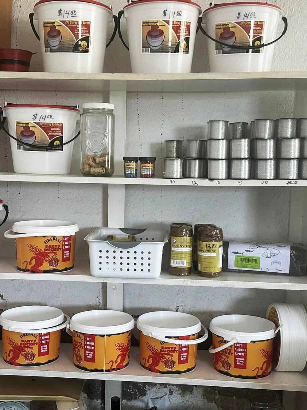Buckets for storage and organization containers on shelves in a storage room or workshop.