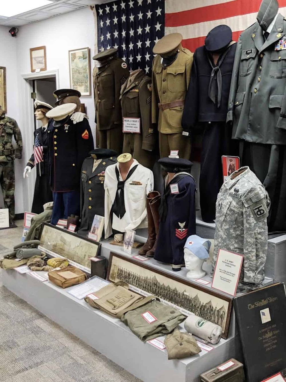 Military uniforms and artifacts displayed at a war history museum.