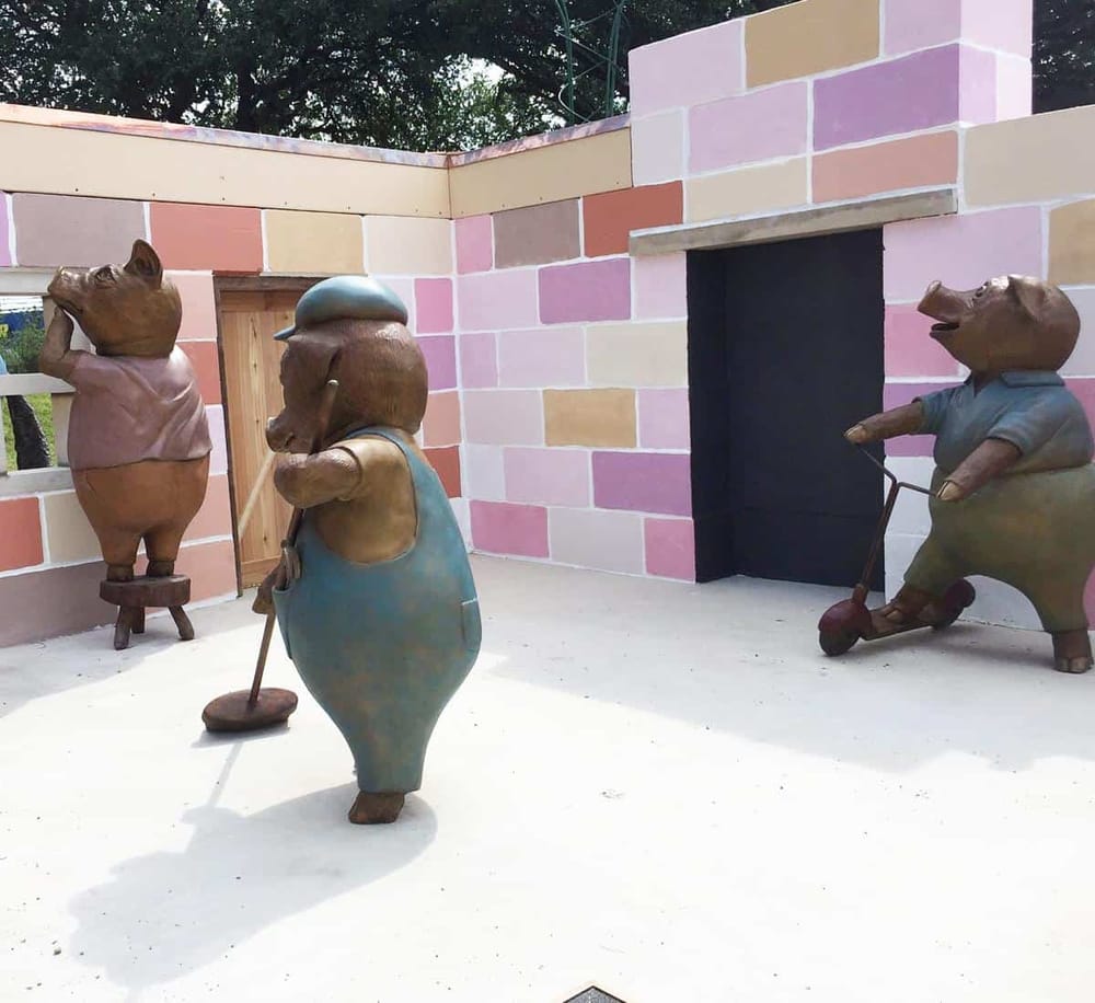 Colorful pig sculptures at Quest for Directions outdoor art installation.