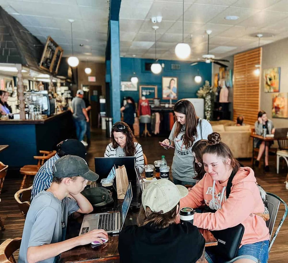 1. Cozy coffee shop with customers working and socializing in a welcoming environment.