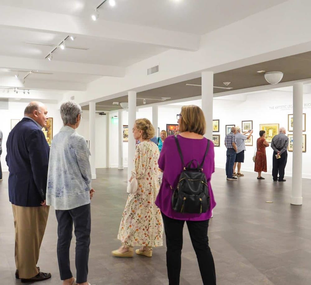 Vibrant art gallery with diverse visitors viewing contemporary and classic artworks, promoting cultural engagement and artistic appreciation.