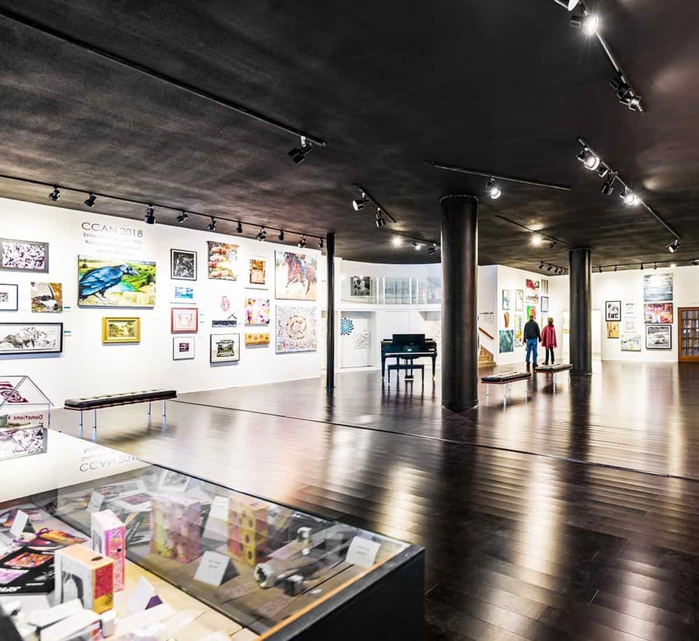 Contemporary art gallery showcasing colorful artwork in a well-lit, modern space for art enthusiasts.