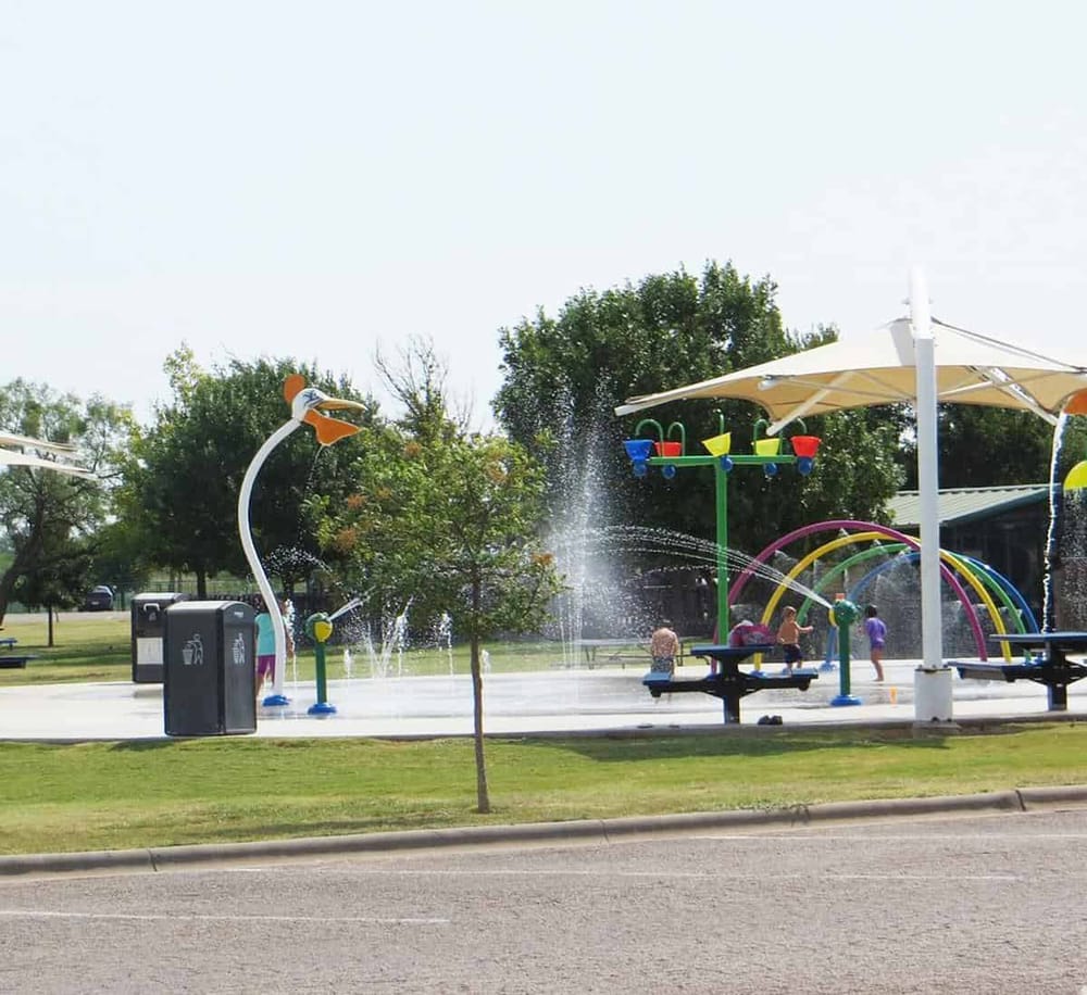 Colorful splash pad water play area for kids at QuestForDirections outdoor park.
