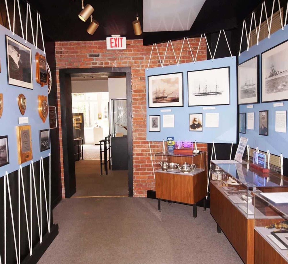 Historic maritime museum exhibit featuring ship artwork and navigational artifacts.