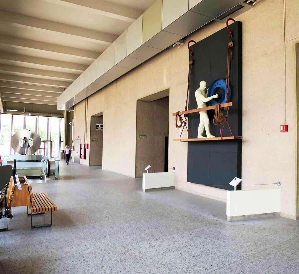 Modern airport interior with artwork and seating area.