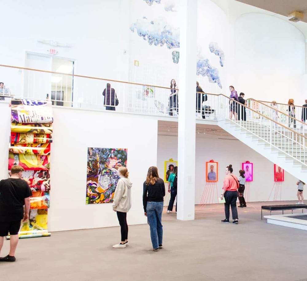 Bright art gallery at QuestForDirections, showcasing vibrant contemporary artworks and sculptures.