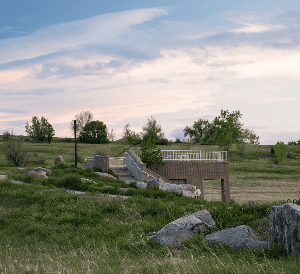 Serene outdoor landscape with stairs and railing, lush greenery, and a peaceful sky, ideal for scenic outdoor adventures.