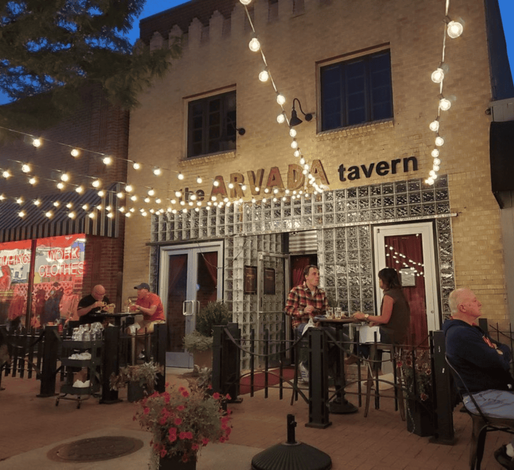 Aesthetic outdoor dining at The Aruba Tavern with string lights and ambient evening atmosphere.