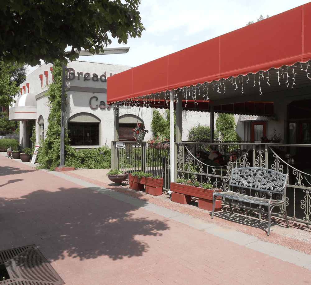 Delray Beach bakery with outdoor seating and festive lighting, perfect for breakfast or coffee.