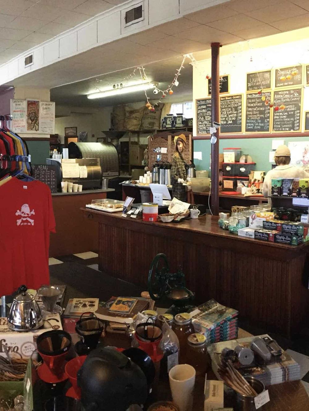 Cozy coffee shop interior with menu boards, warm lighting, and coffee brewing area for a welcoming cafe experience.