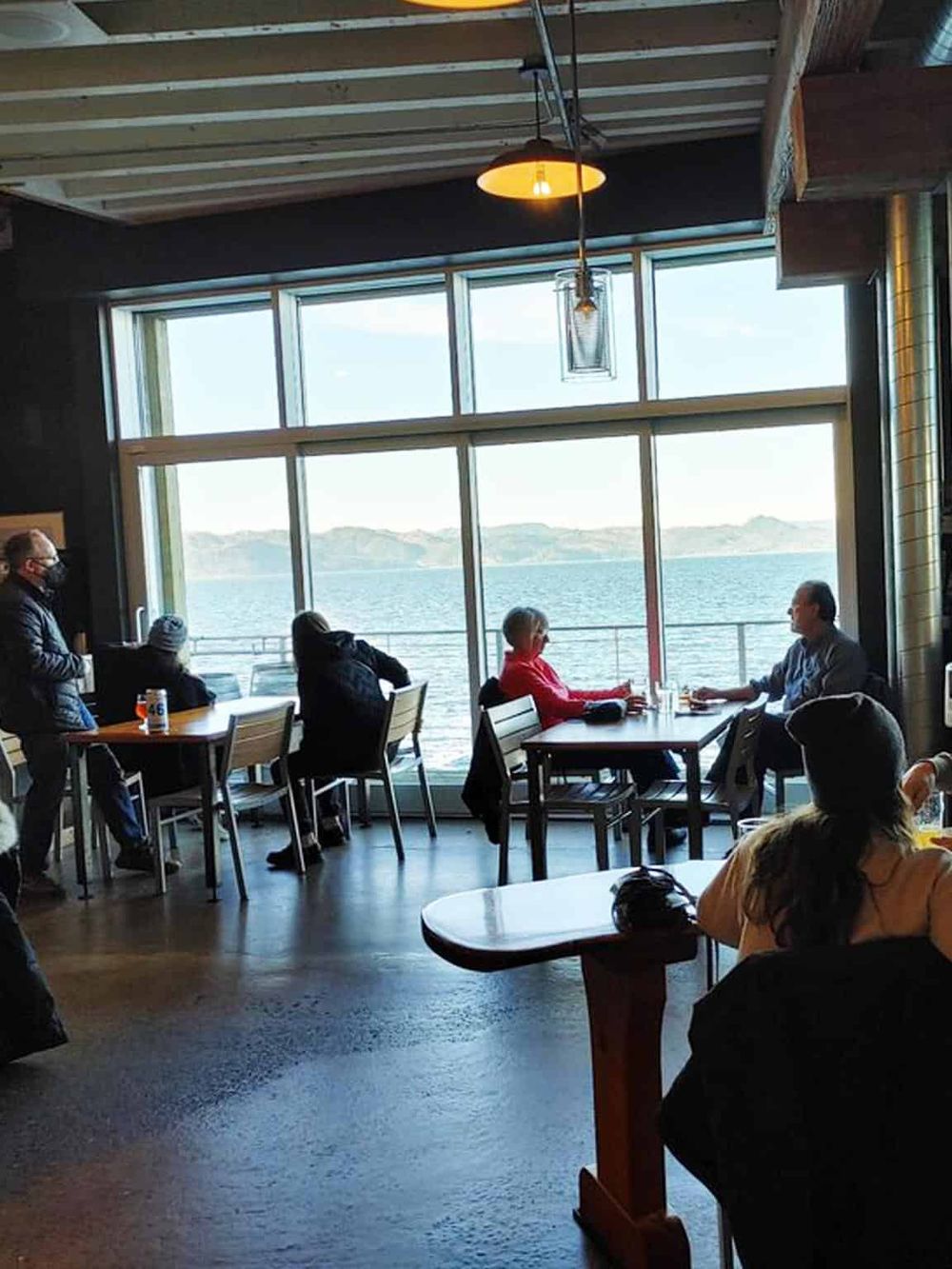 Enjoying waterfront dining at QuestForDirections with scenic ocean views and a cozy restaurant atmosphere.