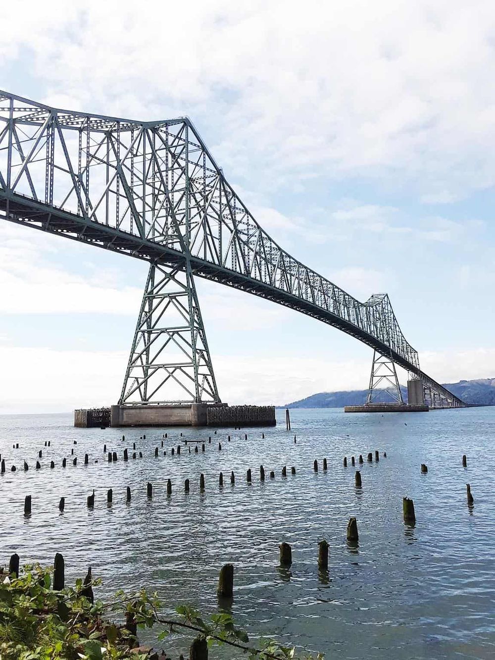 Steel bridge spanning water body, scenic view, transportation infrastructure, Bay Area, California.