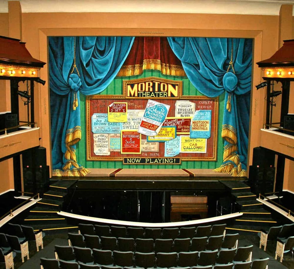 Colorful theater stage with vintage scenery and seating, perfect for live performances and entertainment events.