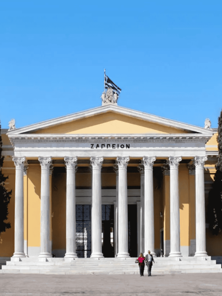 Magnificent Greek-style Zappeion Hall with grand columns and clear blue sky.
