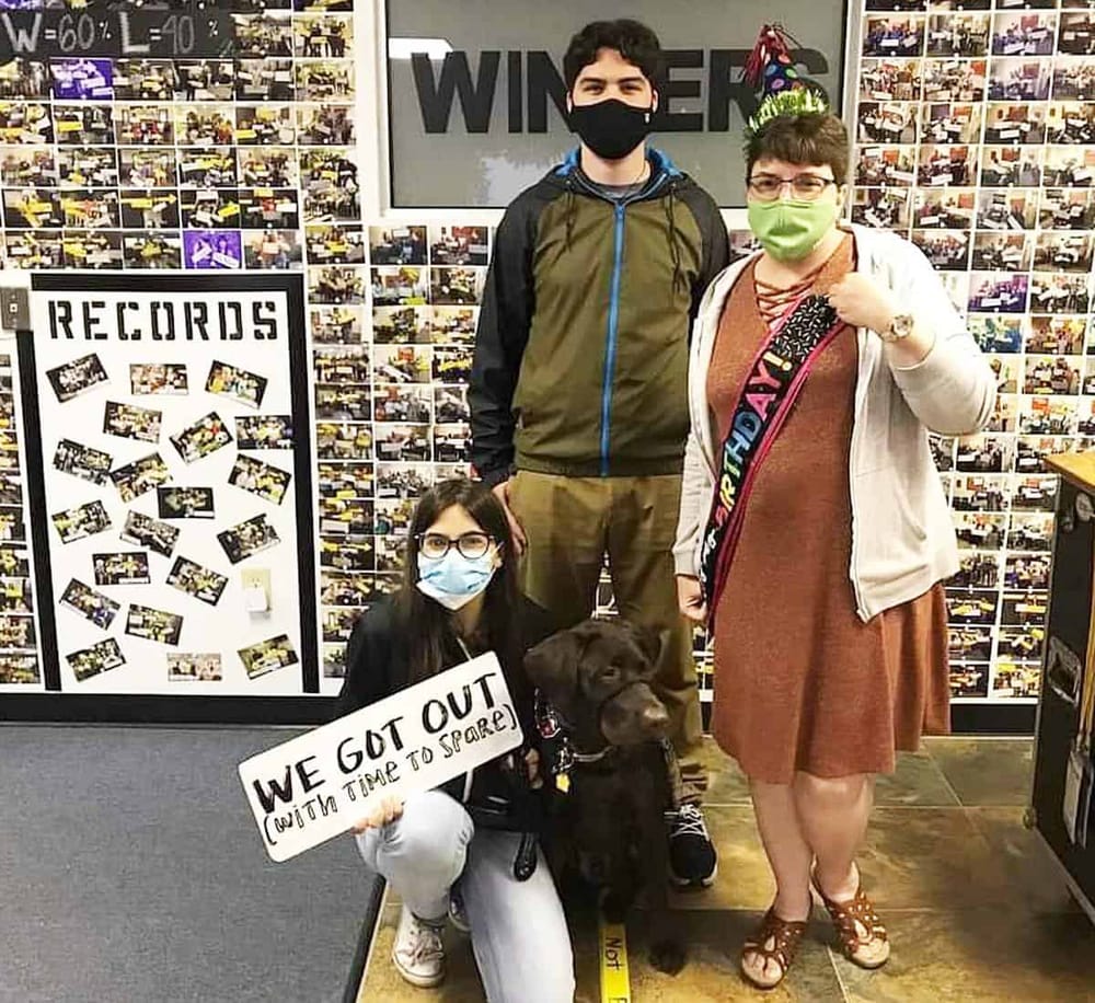 Happy birthday celebration with family at QuestForDirections, showing cheerful moments and pet companionship.