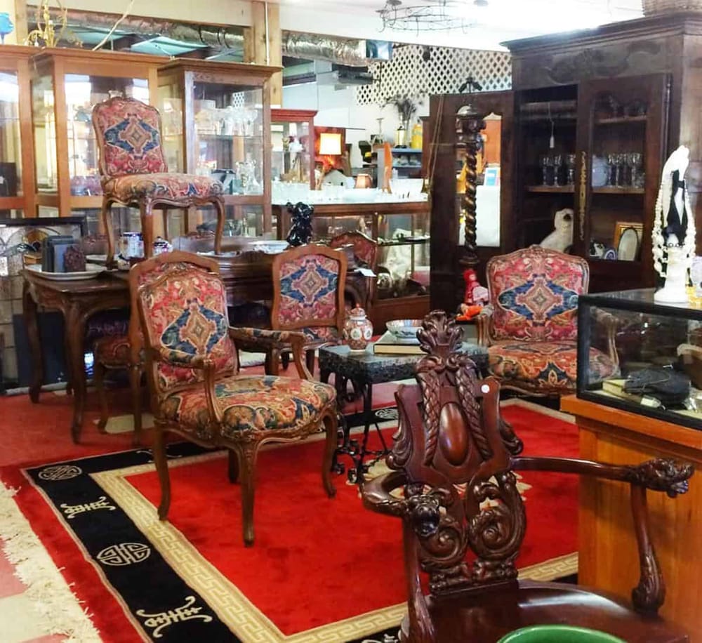 Vintage antique furniture and decor in an upscale estate sale or antique shop.