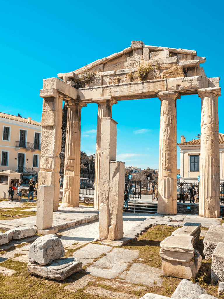 Ancient Greek temple ruins at the Acropolis under a bright blue sky, historical site exploration.