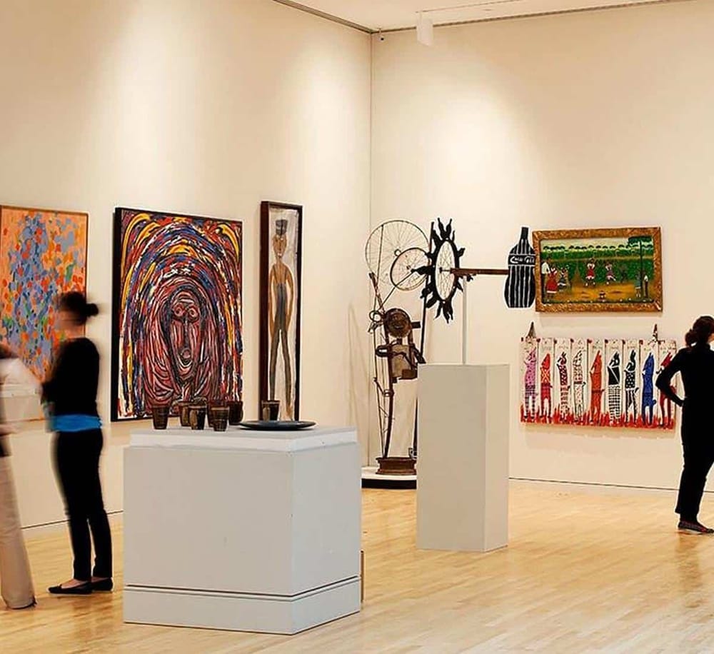 Colorful contemporary art gallery with diverse paintings and sculptures at QuestForDirections exhibit.