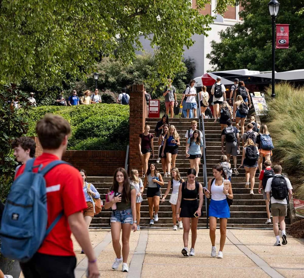 Students walking on campus stairs at the University of Georgia, promoting academic success and campus navigation.