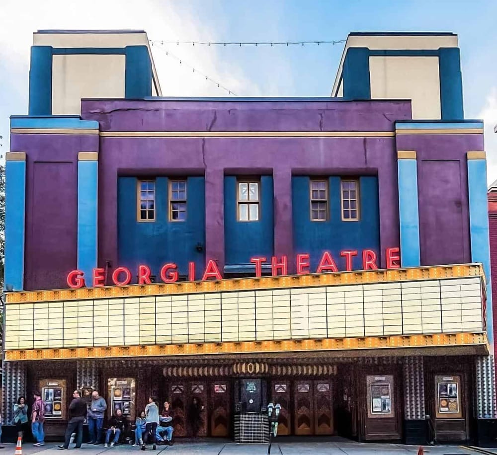 Colorful Georgia Theatre building with neon sign, located in downtown Georgia, perfect for arts and entertainment venues.