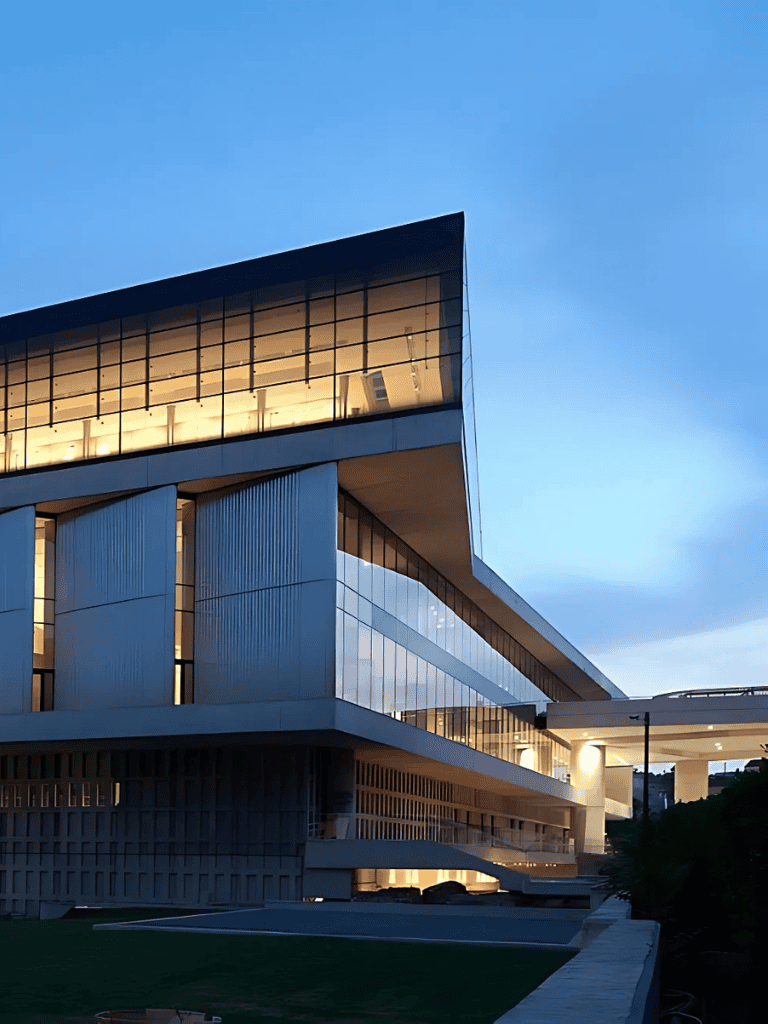 Modern office building with glass facade at dusk, architectural design, QuestforDirections.