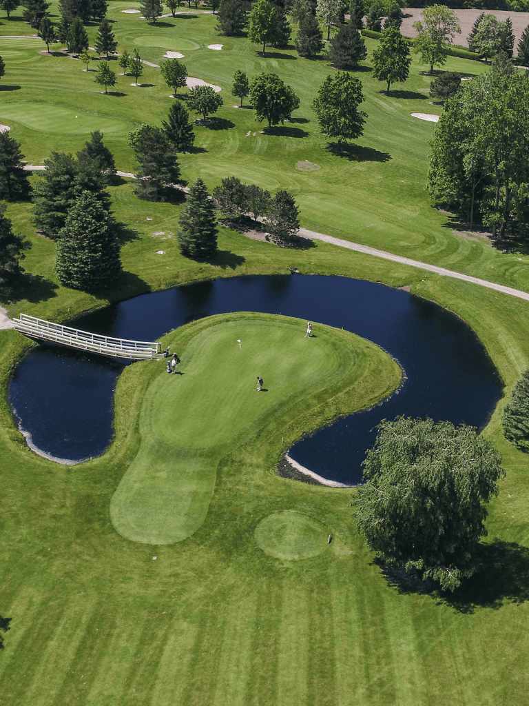 Beautiful golf course with scenic water hazards, lush green fairways, and mature trees for an ideal golf experience.