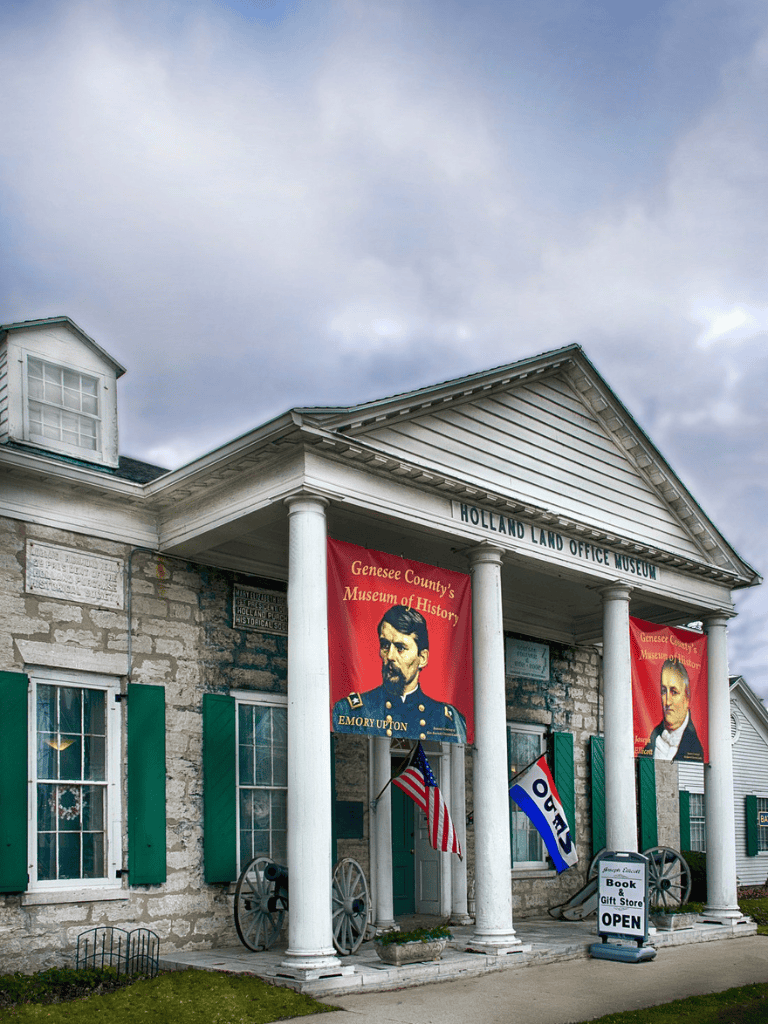Historic Holland Land Office Museum in Genesee County, featuring portraits of local historical figures.