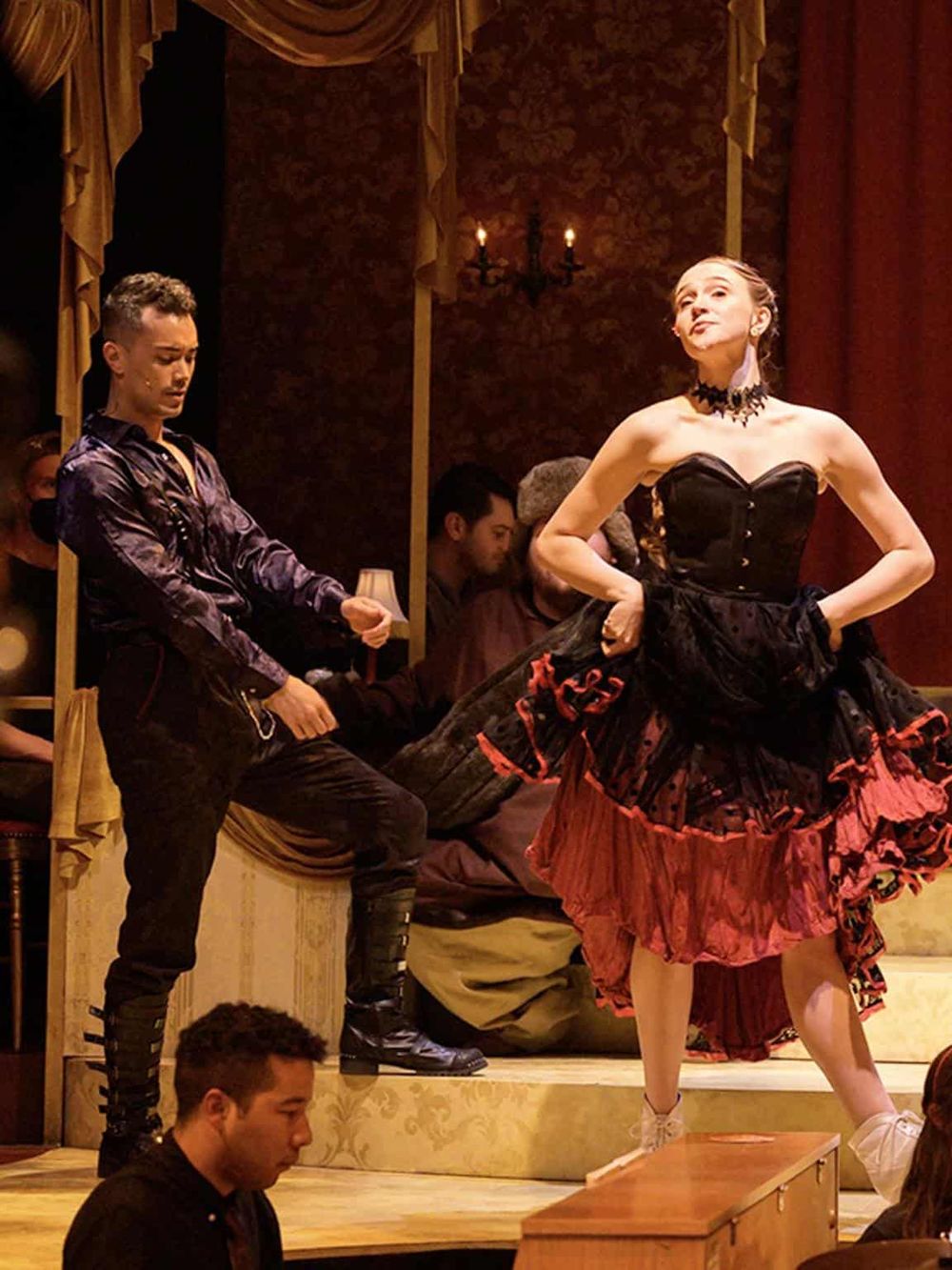 Elegant theatrical performance with actors in vibrant costumes, capturing a dramatic moment on stage for immersive theater experiences.