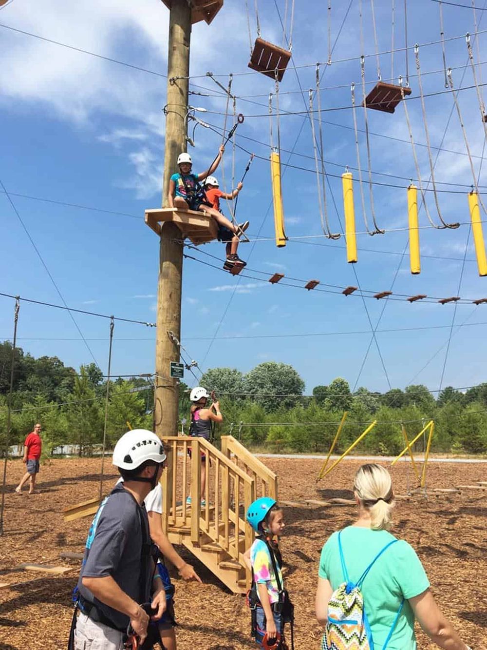 Outdoor adventure zipline course with families at Quest For Directions.