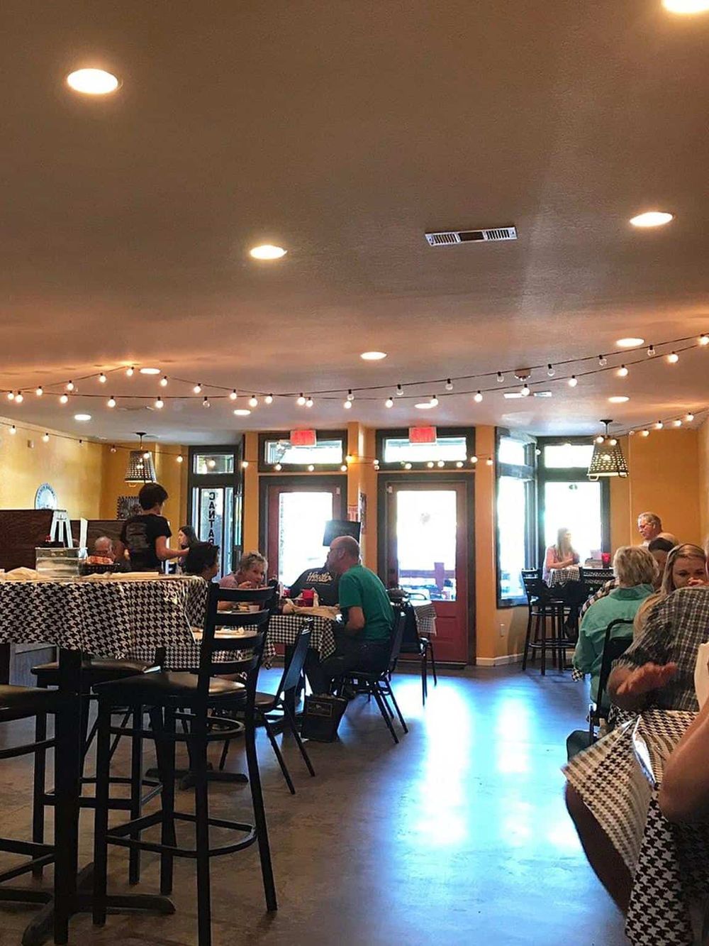 Cozy family restaurant interior with diners enjoying meals and friendly atmosphere, perfect for casual dining.