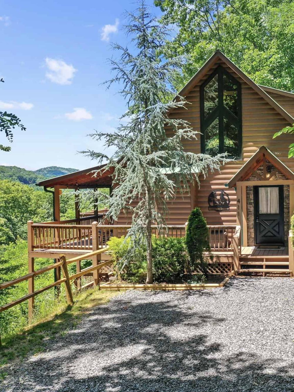 Cozy mountain cabin surrounded by lush trees, showcasing scenic outdoor views and tranquil nature setting.