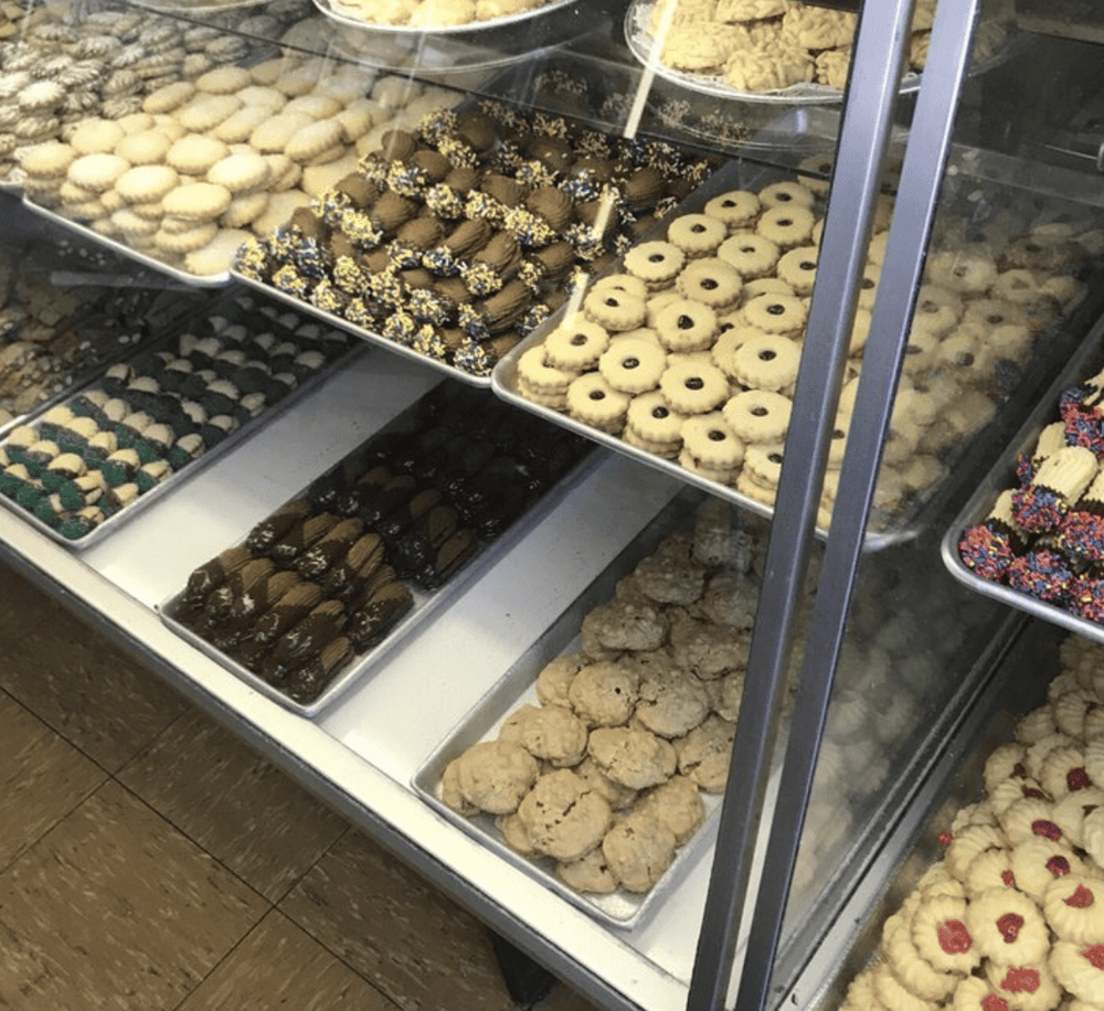Assorted cookies display case at bakery or dessert shop.
