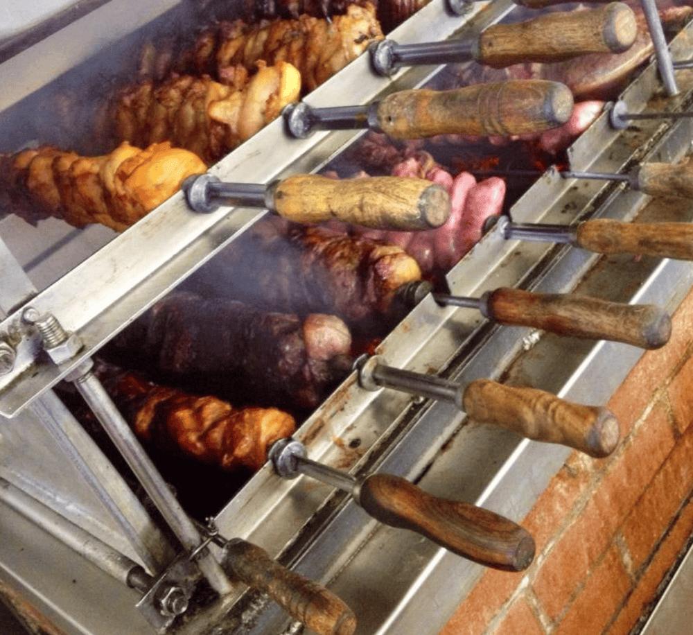 Succulent skewered meats on a rotisserie grill for authentic street food barbecue.