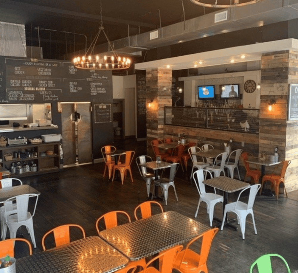 Cozy modern restaurant interior with rustic brick accents and colorful seating, perfect for dining with directions to local food options.