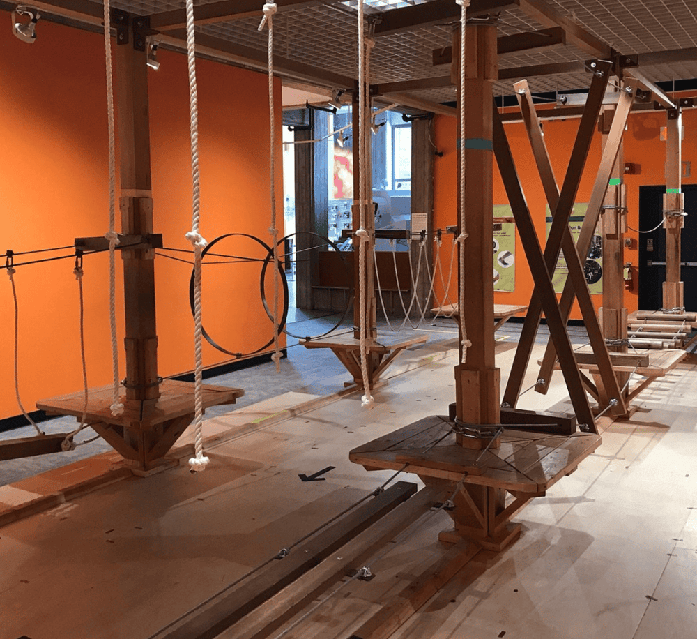 Climbing indoor activity obstacle course at Quest For Directions, emphasizing adventure and physical challenge.