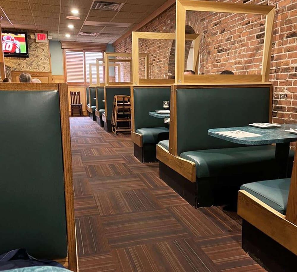 Comfortable restaurant booths with brick walls perfect for dining at QuestForDirections.