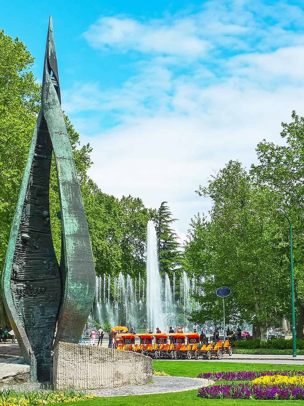 Vivid public park scene with fountain, greenery, and bike rentals, highlighting outdoor activities and local attractions in QuestforDirections.