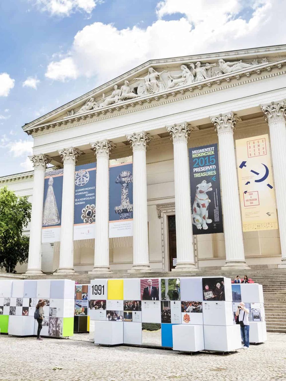 Elegant Greek Revival building showcasing cultural exhibits and art displays, representing historical and modern attractions.