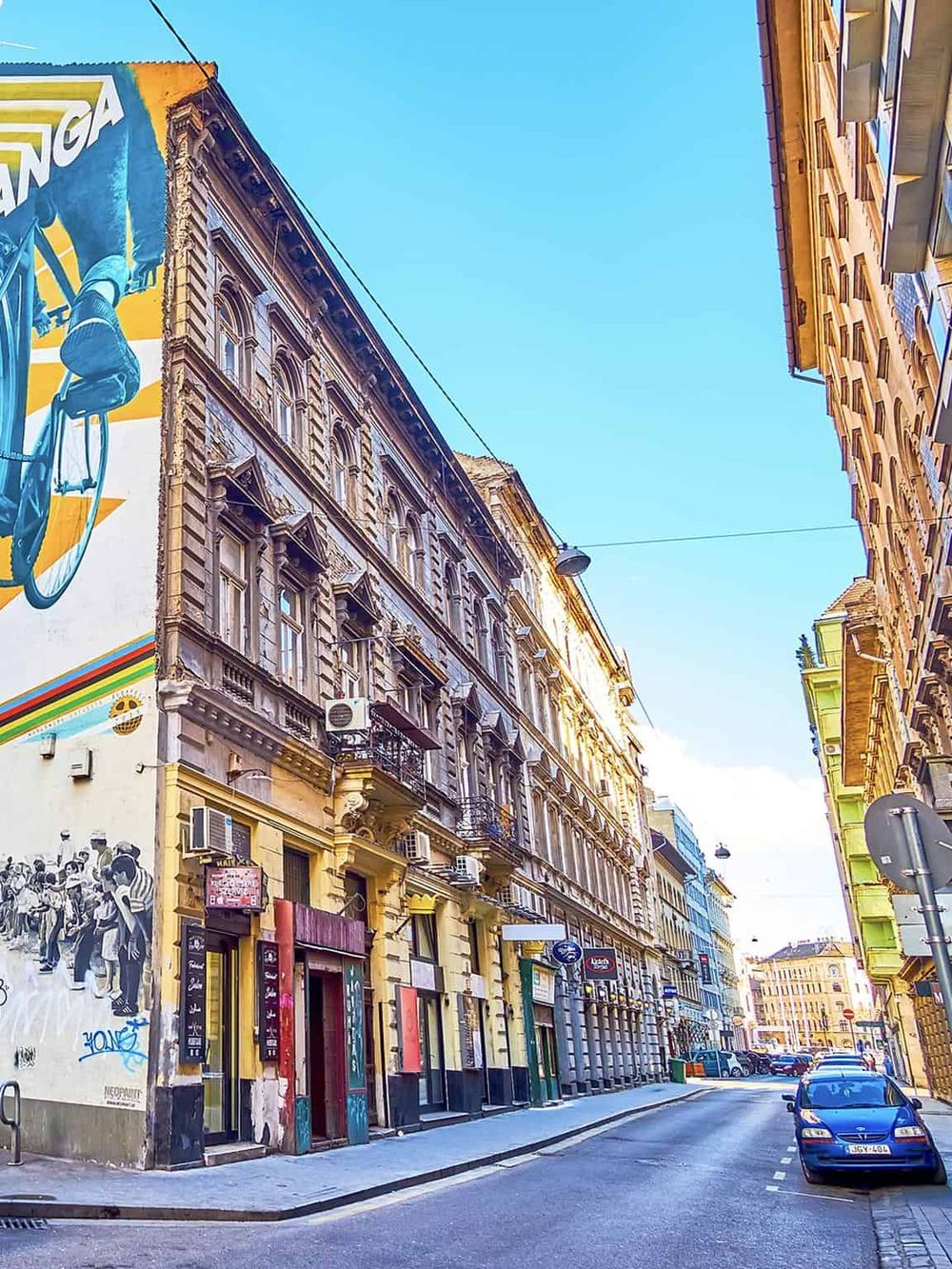 Colorful historic street with vibrant murals and classic European architecture.