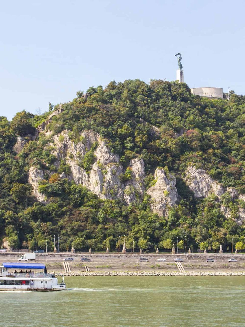 Scenic view of Gellért Hill with Liberty Statue overlooking the Danube River in Budapest, Hungary.