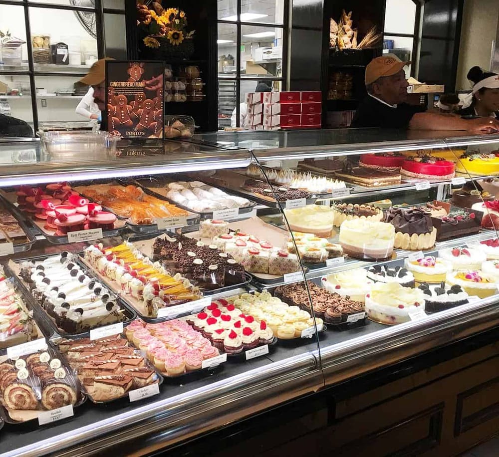 Delicious assorted cakes and pastries displayed in a bakery showcase, perfect for celebrations and sweet cravings.