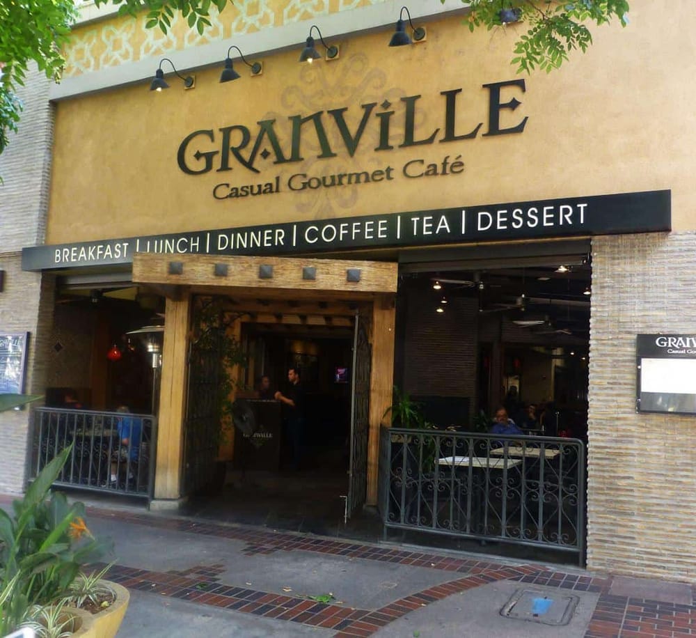 Cozy cafe exterior with outdoor seating at Granville Casual Gourmet Café in a trendy shopping area.