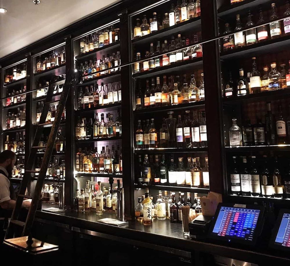 Aisle of spirits and liquors in a high-end bar or liquor store.