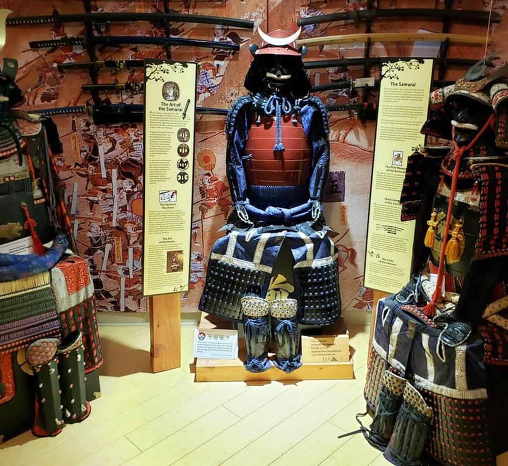 Samurai armor display in a cultural museum showcasing Japanese samurai history and traditional armor craftsmanship.