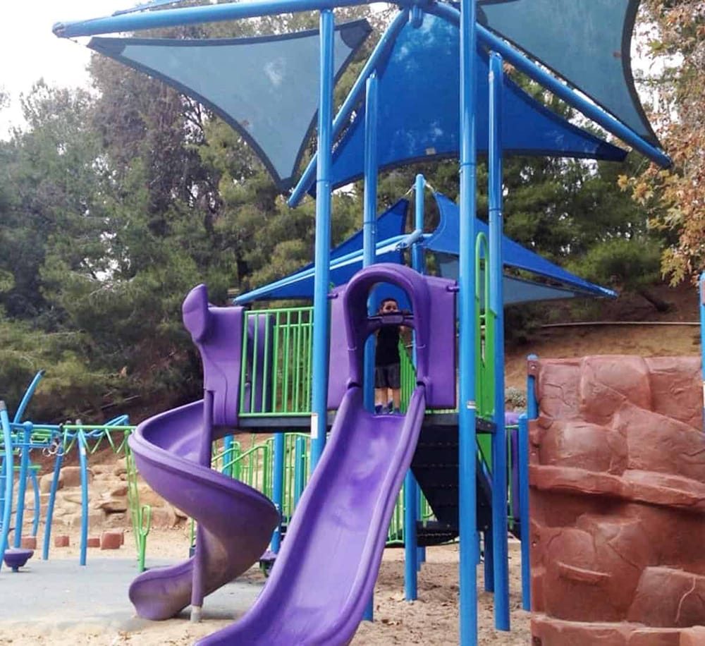 Colorful kids’ playground with slides and climbing structures in outdoor park.
